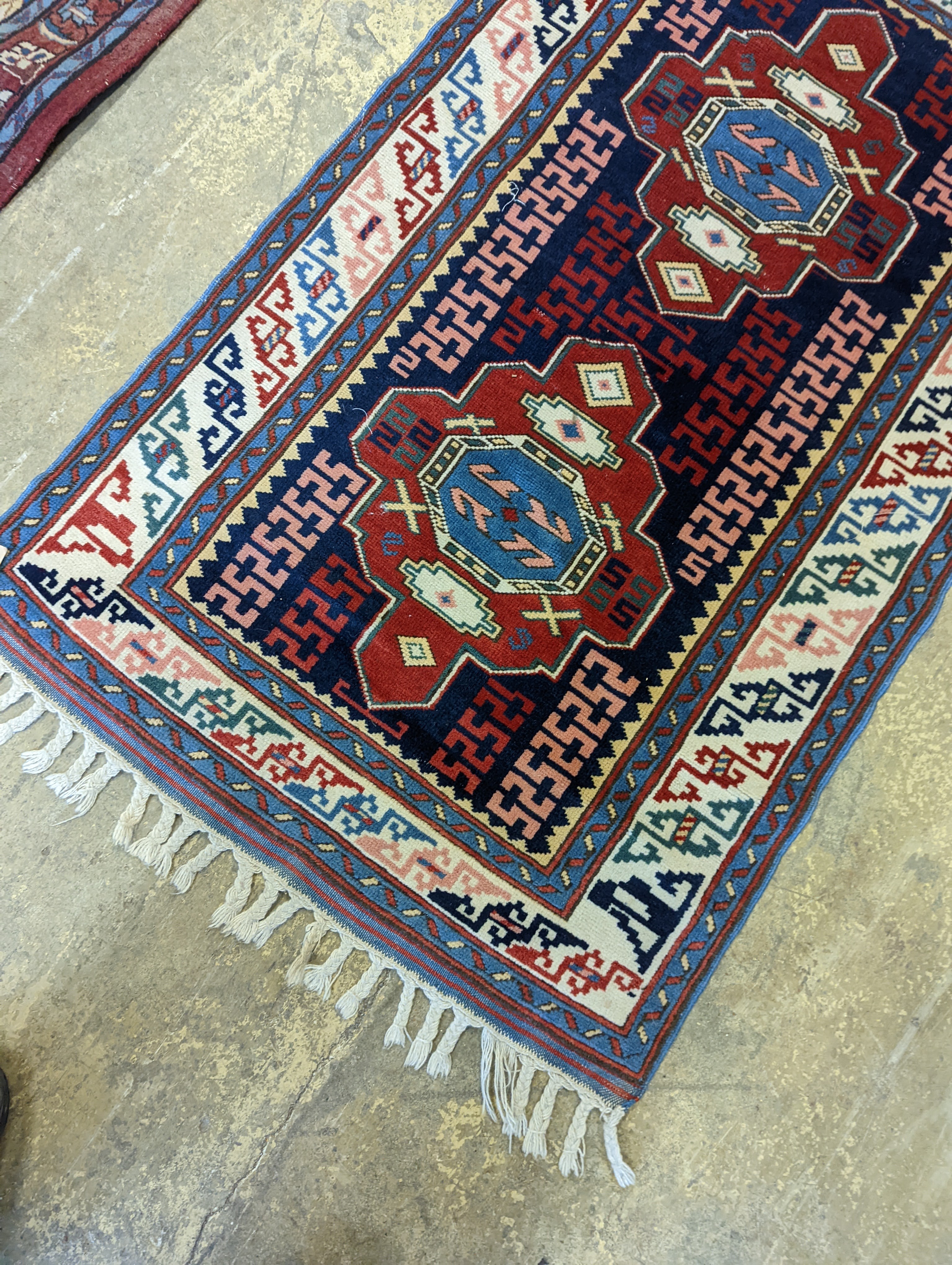 A Caucasian blue ground rug, 126 x 77cm